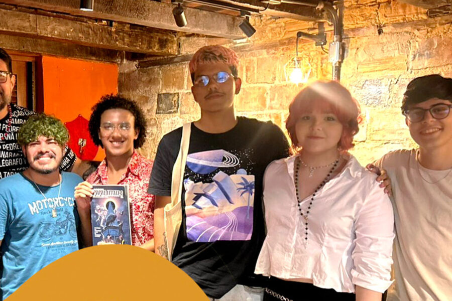 Grupo de artistas de quadrinhos em frente de uma livraria